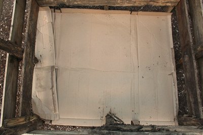 Place a piece of cardboard in the bottom of the planter to smother weeds.