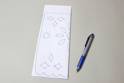 Fold the paper and draw your design
