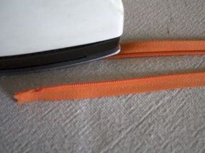 Press open zipper coils.