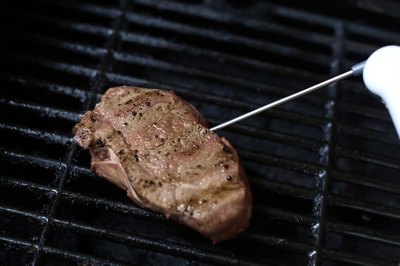 Measuring the temperature on a top sirloin steak.