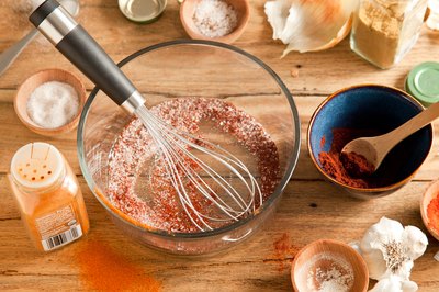 Spices whisked together in a glass mixing bowl.