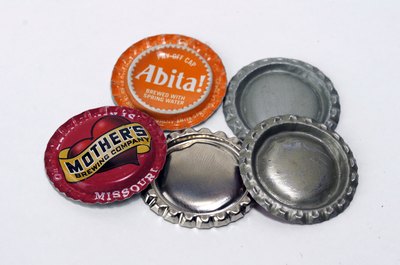Flattened caps ready for craft projects.