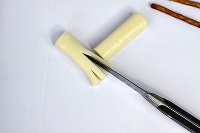 Set the flat side of the cheese on your cutting surface to help steady it.