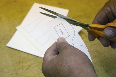 Cut parts from paperboard.