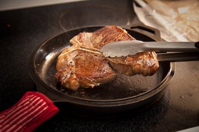 Cooked steak in a cast-iron skillet.