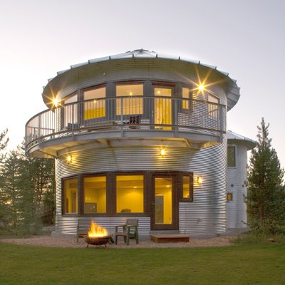 Electric mesh in the floor helps heat this silo home.