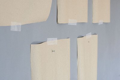 Add picture hanging nails right through the kraft paper.