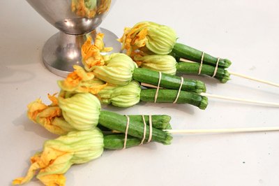 Bundle squash blossoms with a skewer