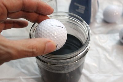 Drop the golf ball in the jar