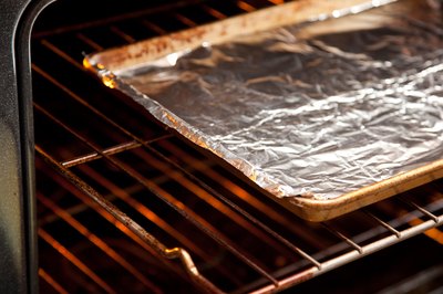 Broiler pan in open oven.