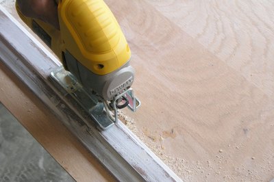 Hold the saw level along the top of the frame to get a straight cut.