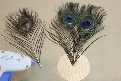 Hot glue feathers to cardstock disk.
