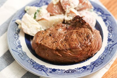 Top sirloin on plate with potatoes.