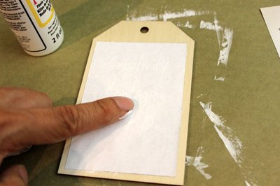 Place the paper image side down on the wood