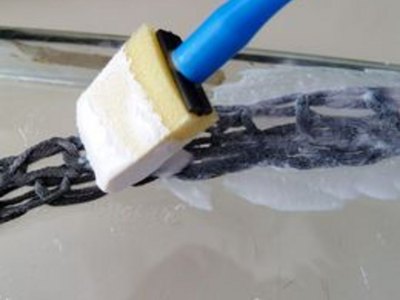 Apply decoupage medium to the yarn chains.