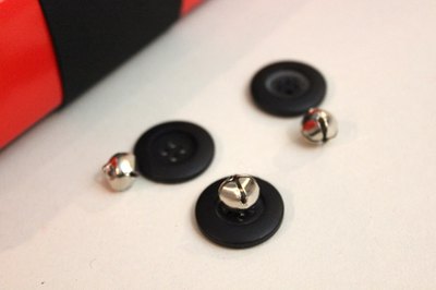 Glue jingle bells to the buttons.