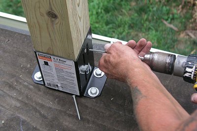 A hammer drill speeds the bolt installation.