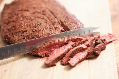Sliced skirt steak on a cutting board.