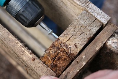 Drill the galvanized wood screws into the wood pallets.