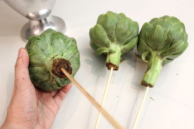Insert skewers into artichokes