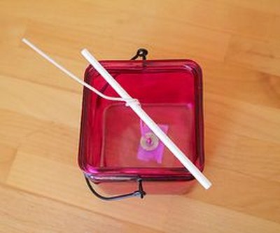 Use a lollipop to keep the wick in place.