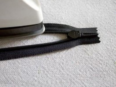 Press open zipper coils.
