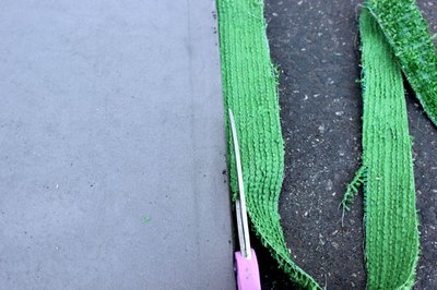 Trim the grass to the edge of the mat