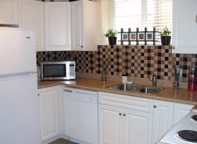 Adhere backsplash materials to a portable board instead of on the actual wall.