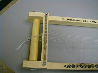 Hook the knot behind the screw and turn the tension rod.
