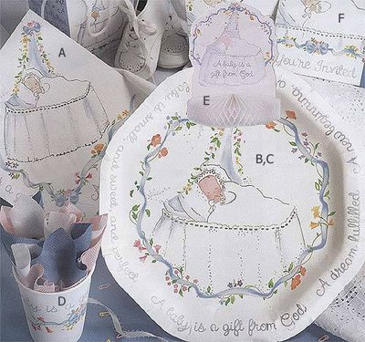Paper products and decorations designed for a christening enhance the party theme.