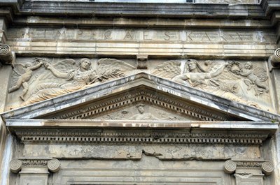 A pediment adorns a building's main entry.