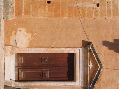 A pediment lends formality to even a simple entrance.