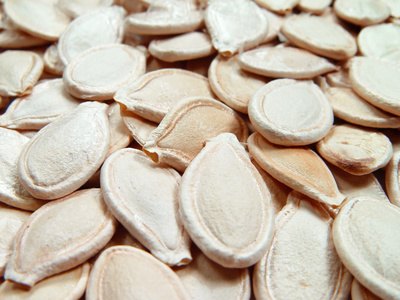 Color pumpkin seeds with markers to designate players if more than one child is tossing at the same time.