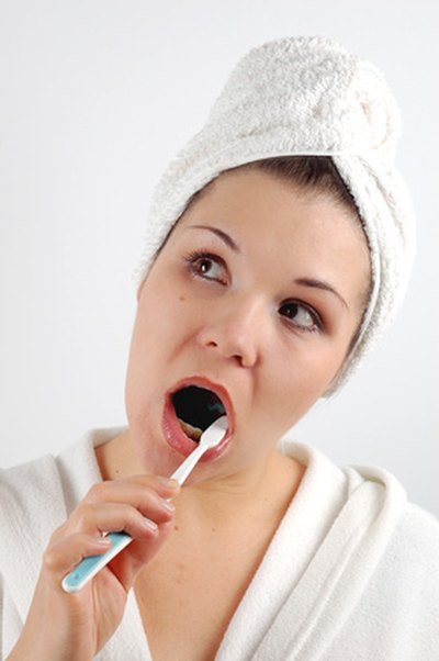 Brushing regularly prevents plaque build-up, which causes black gum spots.