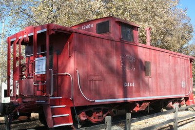 The #3 Engine pulls an authentic wooden caboose.