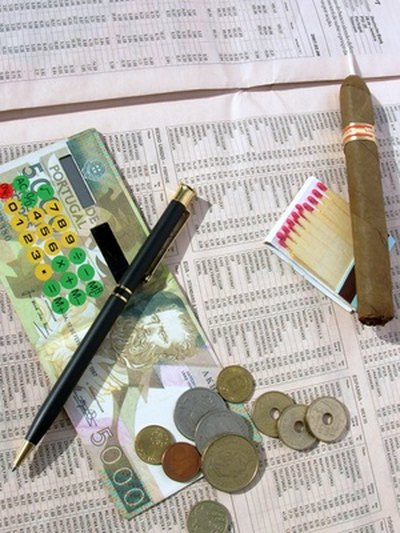 Currency from another country may be glued or taped in a travel journal entry page.