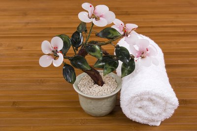 Rolled up white towels and small potted plants can serve as spa decor.