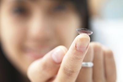 Contact lens on fingertip.
