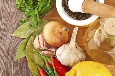 Fresh garlic, onions, bay leaves, cilantro, peppers, and oil