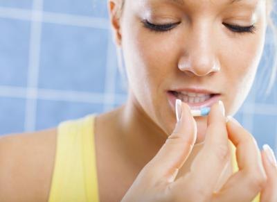 woman holding Clindamycin pill