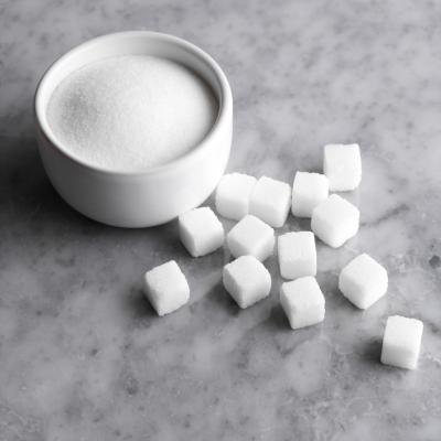 Bowl of sugar and sugarcubes.