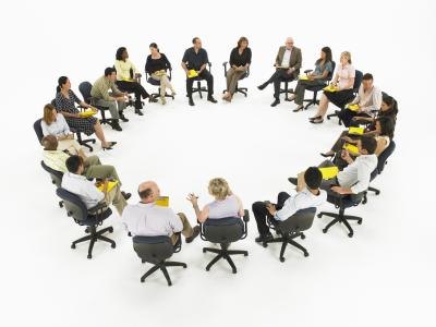 Large group of people sitting in chairs.