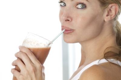 woman holding healthy looking drink