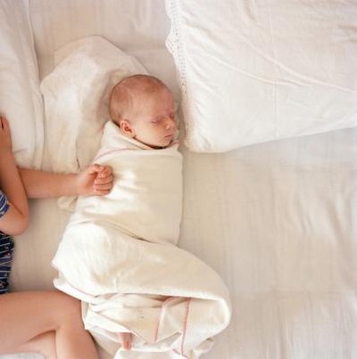 Baby sleeps on bed