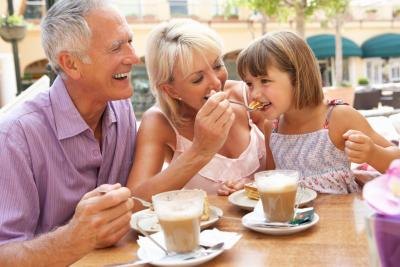 Grandparents eating with granddaughter