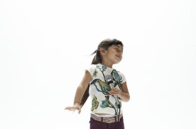 Young girl stops after the music stops while dancing.