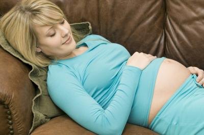 pregnant woman lying on couch