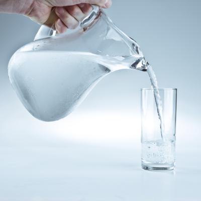 Pitcher of water pouring into a glass.