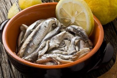 Anchovies with olive oil and lemon in a bowl