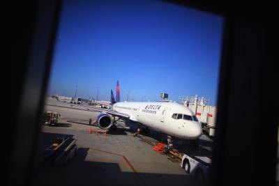 A Delta Airlines plane sits at the gate at LaGuardia Airport, NY